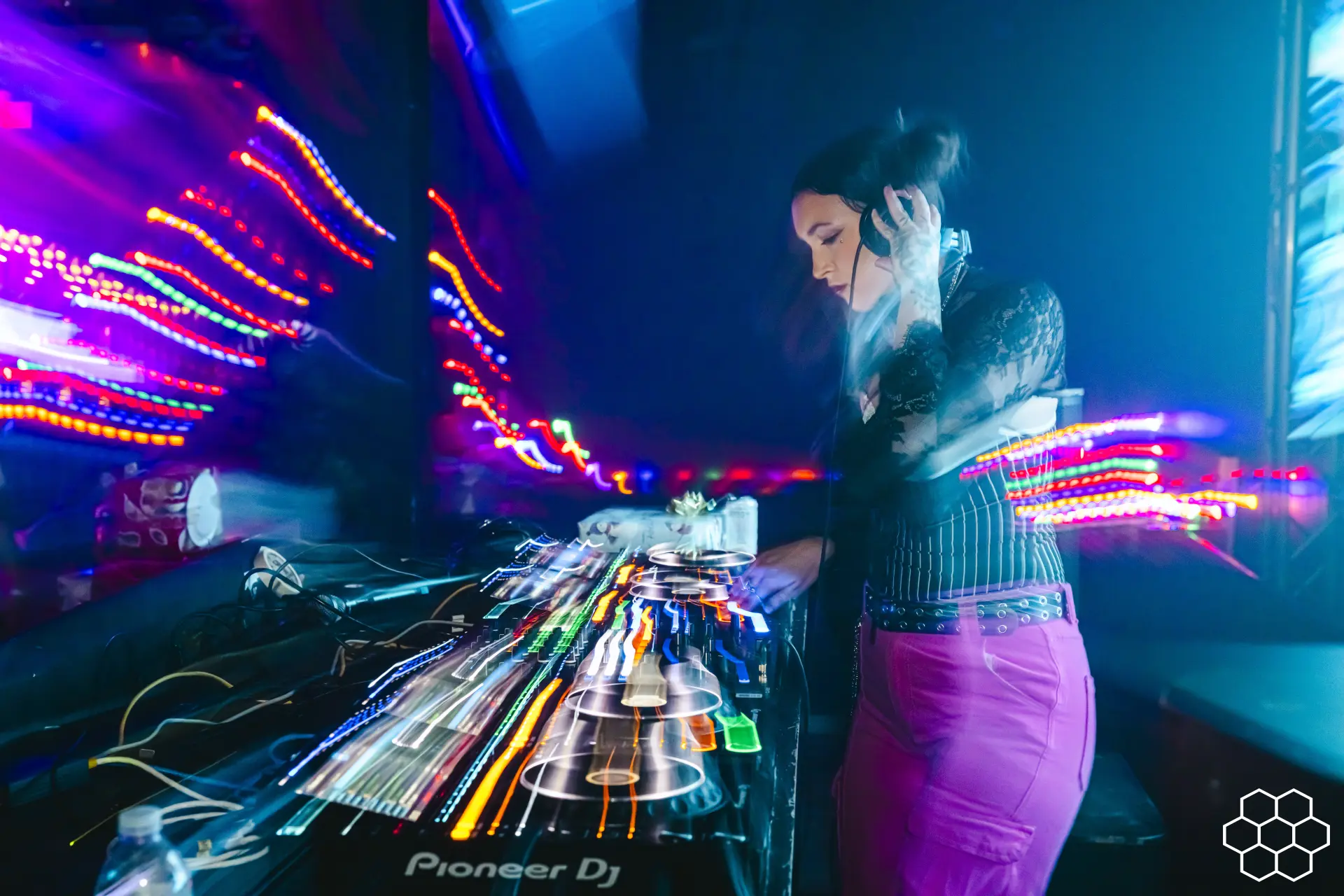 DJ at the decks under stage lights